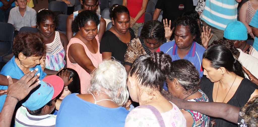 group of australian people at a prayer meeting