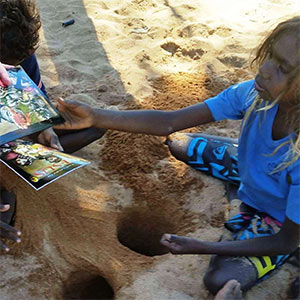 boy in the outback receiving a book of bible stories